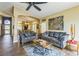 Elegant living room with wood-look flooring, an open concept layout, and bright, inviting natural light at 250 Aspen Bay Ln, Henderson, NV 89012
