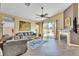 Bright living room with wood floors, a cozy fireplace, and large windows providing ample natural light at 250 Aspen Bay Ln, Henderson, NV 89012