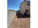 Backyard featuring stone and stucco walls, tan exterior, and desert landscaping at 2539 Early Light Dr, Las Vegas, NV 89142
