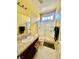 Bathroom featuring tile floors, light yellow walls, vanity, and glass shower at 2539 Early Light Dr, Las Vegas, NV 89142