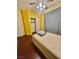 Bedroom featuring hardwood floors, light yellow walls, closet, and natural lighting at 2539 Early Light Dr, Las Vegas, NV 89142