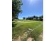 Community park featuring grass, mature trees, playground equipment, and walking path at 2539 Early Light Dr, Las Vegas, NV 89142