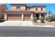 Two-story home featuring a three-car garage, neutral color palette, and well-maintained landscaping at 2539 Early Light Dr, Las Vegas, NV 89142