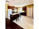 Kitchen featuring dark wood cabinets, granite countertops, and a center island at 2539 Early Light Dr, Las Vegas, NV 89142