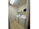 Utility room with front loading washer and dryer, and overhead shelf at 2539 Early Light Dr, Las Vegas, NV 89142