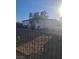 The front of this home has a barred front door and window, xeriscaping, and a dark iron fence at 2888 El Cajon St, Las Vegas, NV 89169