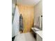 Modern bathroom featuring shower, vertical wood paneling, and bench at 2925 Wigwam Pkwy # 724, Henderson, NV 89074