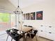 Dining area with a modern table, seating for six, stylish light fixture and sliding glass door at 2925 Wigwam Pkwy # 724, Henderson, NV 89074