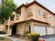 Attractive building exterior featuring a two-story design, tiled roof, garages, and desert landscaping at 2925 Wigwam Pkwy # 724, Henderson, NV 89074
