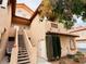 Charming exterior of a multi-story home with a stairway and well-maintained landscaping at 2925 Wigwam Pkwy # 724, Henderson, NV 89074