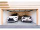 Spacious garage featuring two cars and overhead storage racks for organization at 2925 Wigwam Pkwy # 724, Henderson, NV 89074