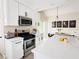 A modern kitchen featuring white cabinets, stainless steel appliances, and an island with seating at 2925 Wigwam Pkwy # 724, Henderson, NV 89074