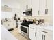 Well-lit kitchen featuring white cabinets, stainless steel appliances, and sleek countertops at 2925 Wigwam Pkwy # 724, Henderson, NV 89074