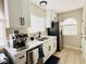 Bright kitchen boasts white cabinets, stainless steel appliances, and a cozy coffee station at 2925 Wigwam Pkwy # 724, Henderson, NV 89074