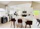 Bright kitchen with white cabinets, stainless steel appliances, a center island with seating, and sliding glass doors at 2925 Wigwam Pkwy # 724, Henderson, NV 89074
