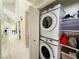 Laundry area with stacked washer and dryer unit and shelving for storage at 2925 Wigwam Pkwy # 724, Henderson, NV 89074
