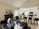 Open-concept living room showcasing the modern fireplace, kitchen, and breakfast bar at 2925 Wigwam Pkwy # 724, Henderson, NV 89074