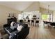 Open-concept living space with dining area, featuring a fireplace and modern furniture at 2925 Wigwam Pkwy # 724, Henderson, NV 89074