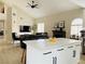 Open concept space featuring a fireplace, kitchen island and seamlessly connected living area at 2925 Wigwam Pkwy # 724, Henderson, NV 89074