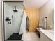 Contemporary shower with black hardware, marble-look tile, a glass enclosure, and wood accent wall at 2925 Wigwam Pkwy # 724, Henderson, NV 89074