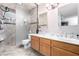 Bathroom with double sinks, stone countertop, tile flooring, and a glass-enclosed walk-in shower at 3138 Valleywood Rd, Henderson, NV 89014