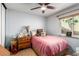 Cozy bedroom with a ceiling fan, comfortable bed, and natural light from the window at 3138 Valleywood Rd, Henderson, NV 89014