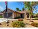 Charming single-story home featuring stone accents, a two-car garage, and low-maintenance desert landscaping at 3138 Valleywood Rd, Henderson, NV 89014