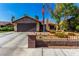 Charming single-story home featuring stone accents, a two-car garage, and low-maintenance desert landscaping at 3138 Valleywood Rd, Henderson, NV 89014