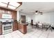Eat-in kitchen featuring tile flooring, stainless appliances, wood cabinets, and dining area with seating at 3138 Valleywood Rd, Henderson, NV 89014