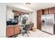 A kitchen area has been converted into a home office space with a desk, stainless refrigerator, and tiled floors at 3138 Valleywood Rd, Henderson, NV 89014