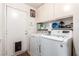 Clean laundry room with washer, dryer, storage cabinets, and access to the exterior at 3138 Valleywood Rd, Henderson, NV 89014