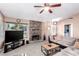 Cozy living room featuring a brick fireplace, plush carpeting, and plenty of natural light at 3138 Valleywood Rd, Henderson, NV 89014