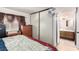 Bedroom featuring a large closet with sliding doors, a dresser, and an ensuite bathroom at 3138 Valleywood Rd, Henderson, NV 89014