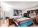 Bedroom with hardwood floors, a king bed with colorful bedding, and a cityscape print above the headboard at 3138 Valleywood Rd, Henderson, NV 89014