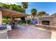 Covered patio featuring a fireplace, dining area, and outdoor lounge area at 3138 Valleywood Rd, Henderson, NV 89014