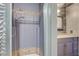 Ensuite Bathroom provides an updated shower with grey toned tile, stone accents, and glass doors at 3266 Mountain Spring Rd, Las Vegas, NV 89146