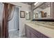 The ensuite bathroom provides an elegant vanity and a glass enclosed shower featuring decorative stone accents at 3266 Mountain Spring Rd, Las Vegas, NV 89146