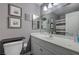 This elegant bathroom features a designer vanity, marble countertops, designer accents and a large framed mirror at 3266 Mountain Spring Rd, Las Vegas, NV 89146