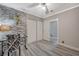 Bright bedroom with laminate floors, brick accent wall, and double-door closet at 3266 Mountain Spring Rd, Las Vegas, NV 89146