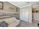 Neutral bedroom with laminate floors, whitewashed wood accent wall, and a double-door closet at 3266 Mountain Spring Rd, Las Vegas, NV 89146