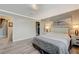 Spacious bedroom provides an ensuite, a picture window, neutral paint, and light grey laminate flooring at 3266 Mountain Spring Rd, Las Vegas, NV 89146