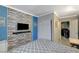 Bright bedroom featuring an accent wall, flat-screen TV, a bed, closet and access to laundry room at 3266 Mountain Spring Rd, Las Vegas, NV 89146