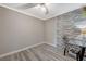Clean bedroom with laminate flooring, a brick accent wall, and neutral decor at 3266 Mountain Spring Rd, Las Vegas, NV 89146