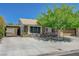 Inviting single-story home featuring a covered carport, two-car garage, and a large tree in the front yard at 3266 Mountain Spring Rd, Las Vegas, NV 89146