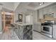 Updated kitchen has a stainless steel stove and microwave, a breakfast bar with barstool seating and laminate floors at 3266 Mountain Spring Rd, Las Vegas, NV 89146