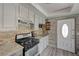 Functional kitchen with stainless steel oven, range, and granite countertops plus access to front entry at 3266 Mountain Spring Rd, Las Vegas, NV 89146