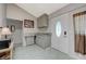 Well-lit kitchenette with gray cabinets, tile flooring, and a granite countertop at 3266 Mountain Spring Rd, Las Vegas, NV 89146