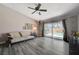 The living room has a sliding glass door which opens onto a backyard pool, gray toned walls, and light gray laminate flooring at 3266 Mountain Spring Rd, Las Vegas, NV 89146