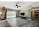 Inviting living room with ceiling fan and sliding doors to outdoor pool area with natural lighting at 3266 Mountain Spring Rd, Las Vegas, NV 89146