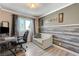 Office or spare bedroom provides a seating area, picture window, stylish chair and desk, and laminate floors at 3266 Mountain Spring Rd, Las Vegas, NV 89146